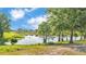 This home features a picturesque pond view with lush greenery and beautiful reflections at 2293 Caspian Dr, Lakeland, FL 33805