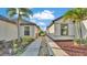 Landscaped side yard with a walkway and decorative rocks between two homes at 2293 Caspian Dr, Lakeland, FL 33805