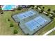Aerial view of community tennis and basketball courts with professional lighting and shade trees at 2293 Caspian Dr, Lakeland, FL 33805