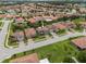 Aerial view showcasing a residential neighborhood with well-maintained lawns and tiled roofs at 2317 Bella Luna Cir, Lakeland, FL 33810
