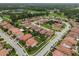 Aerial shot showcases neighborhood, beautiful street view, manicured lawns, and mature trees at 2317 Bella Luna Cir, Lakeland, FL 33810