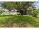 Expansive backyard with lush grass and mature trees, perfect for outdoor living at 2317 Bella Luna Cir, Lakeland, FL 33810