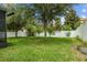 Well-maintained backyard with lush green grass and mature trees at 2317 Bella Luna Cir, Lakeland, FL 33810