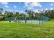 Community basketball court surrounded by a green fence and lush greenery for outdoor recreation at 2317 Bella Luna Cir, Lakeland, FL 33810