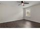 Well-lit bedroom features a ceiling fan, window, and dark wood-look flooring at 2317 Bella Luna Cir, Lakeland, FL 33810