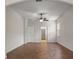 Bedroom with wood floors, ceiling fan, and ensuite bathroom with walk in closet at 2317 Bella Luna Cir, Lakeland, FL 33810
