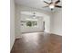 Bonus room with wood floors, arched doorway, and natural light from the surrounding windows at 2317 Bella Luna Cir, Lakeland, FL 33810
