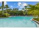 Beautiful community pool with plenty of seating and lush landscaping at 2317 Bella Luna Cir, Lakeland, FL 33810