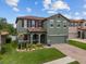 Charming two-story home boasts an attached two-car garage, brick-paved driveway, and lush landscaping at 2317 Bella Luna Cir, Lakeland, FL 33810