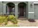Inviting front entrance with a brick walkway, arched entryway, and lush, colorful landscaping at 2317 Bella Luna Cir, Lakeland, FL 33810