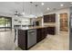 Gourmet kitchen boasts a granite island, a stainless steel dishwasher, and dark wood cabinets at 2317 Bella Luna Cir, Lakeland, FL 33810