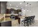 Bright kitchen boasts stainless steel appliances, dark cabinets, granite countertops, and an island with seating at 2317 Bella Luna Cir, Lakeland, FL 33810
