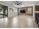 Open-concept living room featuring a reclaimed wood accent wall, a ceiling fan, and access to the lanai at 2317 Bella Luna Cir, Lakeland, FL 33810