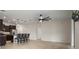 Open-concept living area with a kitchen island, barstool seating, tile floors, and a ceiling fan at 2317 Bella Luna Cir, Lakeland, FL 33810