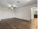 Open living room showcasing new flooring and an archway leading to the bathroom at 2317 Bella Luna Cir, Lakeland, FL 33810