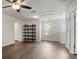 Bright living room featuring updated flooring, a ceiling fan, and a dark wood bookshelf at 2317 Bella Luna Cir, Lakeland, FL 33810