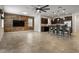 Open-concept living space with a wood accent wall, kitchen island with barstools, and tile flooring at 2317 Bella Luna Cir, Lakeland, FL 33810