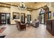 Lobby area with comfortable seating and elegant chandeliers and a view of the gym at 2317 Bella Luna Cir, Lakeland, FL 33810