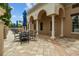 Charming outdoor patio with ample seating under elegant arches and a bright blue sky at 2317 Bella Luna Cir, Lakeland, FL 33810