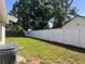 Well-maintained backyard with lush green grass and a newly installed white vinyl fence at 2323 Ridgeview Dr, Lakeland, FL 33810