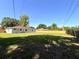 Spacious backyard with a well-kept lawn, bordered by a mix of wood and white fencing at 2323 Ridgeview Dr, Lakeland, FL 33810