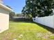 Expansive backyard featuring a lush lawn with a combination of white and wood fencing at 2323 Ridgeview Dr, Lakeland, FL 33810