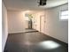 Spacious basement with painted concrete floor, white walls, and visible utilities at 2323 Ridgeview Dr, Lakeland, FL 33810