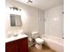 Clean bathroom with vanity, toilet, shower and tub combination, and tiled walls at 2323 Ridgeview Dr, Lakeland, FL 33810