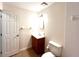Well-lit bathroom with vanity, toilet, and towel rack at 2323 Ridgeview Dr, Lakeland, FL 33810