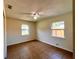 Bedroom features tiled floors, a ceiling fan, and two windows offering natural light at 2323 Ridgeview Dr, Lakeland, FL 33810
