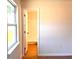 Bright bedroom featuring tile floors, a window and a doorway leading to the bathroom at 2323 Ridgeview Dr, Lakeland, FL 33810