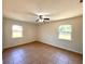 Bright bedroom with tile floors, two windows, and a ceiling fan at 2323 Ridgeview Dr, Lakeland, FL 33810