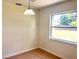 Cozy dining area featuring tile floors, a window with a backyard view, and hanging light fixture at 2323 Ridgeview Dr, Lakeland, FL 33810