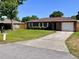 Cozy brick home features an attached garage and a long driveway at 2323 Ridgeview Dr, Lakeland, FL 33810