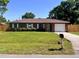 Charming single-story brick home with a well-manicured lawn and attached garage at 2323 Ridgeview Dr, Lakeland, FL 33810