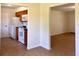 Kitchen featuring tile floors, white appliances, wood cabinets, and an adjacent living area at 2323 Ridgeview Dr, Lakeland, FL 33810