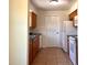 Kitchen featuring tile floors, wood cabinets, a double sink, and white appliances at 2323 Ridgeview Dr, Lakeland, FL 33810
