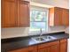 Kitchen sink featuring a view of the backyard from the window above and wood cabinets at 2323 Ridgeview Dr, Lakeland, FL 33810