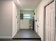 Utility room featuring a water heater, a small window, and gray painted floors at 2323 Ridgeview Dr, Lakeland, FL 33810