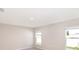 Sunlit bedroom with two windows, carpeted floors, and neutral-colored walls at 2331 Northumberland Ct, Haines City, FL 33844