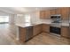 Spacious kitchen featuring stainless steel appliances, stylish cabinetry, and a center island with seating at 2331 Northumberland Ct, Haines City, FL 33844