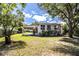 Exterior showcasing a covered parking area and the home’s backyard with mature trees at 2710 Fairmount Ave, Lakeland, FL 33803