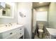 A full bathroom with a toilet, shower, vanity, and additional storage and counter space at 2710 Fairmount Ave, Lakeland, FL 33803