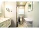 Full bathroom featuring a toilet, vanity, shower with curtain, and storage cart at 2710 Fairmount Ave, Lakeland, FL 33803