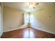 Comfortable bedroom with wood-look floors, ceiling fan, and bright windows at 2710 Fairmount Ave, Lakeland, FL 33803