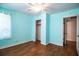 Cozy bedroom with a ceiling fan, wood-look floors, and an open closet at 2710 Fairmount Ave, Lakeland, FL 33803