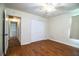 A cozy bedroom with a bi-fold closet, wood-look floors, and natural light at 2710 Fairmount Ave, Lakeland, FL 33803