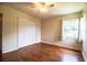 Spacious bedroom featuring wood-look floors, large closet, and a bright window at 2710 Fairmount Ave, Lakeland, FL 33803