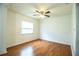 Bright bedroom featuring wood-look floors, ceiling fan, and a window, offering a comfortable space at 2710 Fairmount Ave, Lakeland, FL 33803