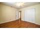 A charming bedroom featuring wood-look floors and a large closet at 2710 Fairmount Ave, Lakeland, FL 33803